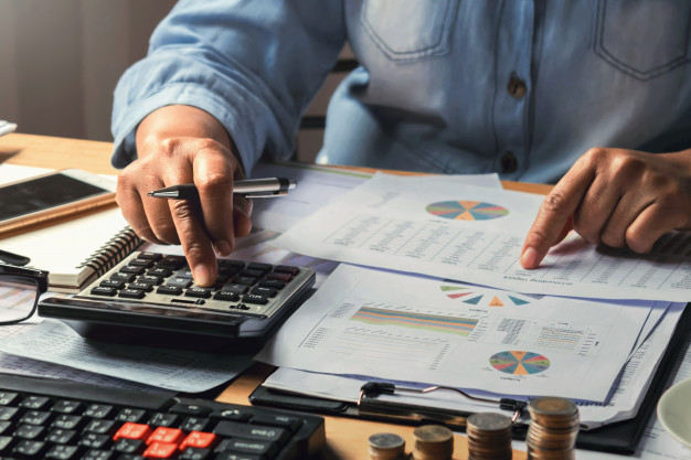 businesswoman working using calculator 
