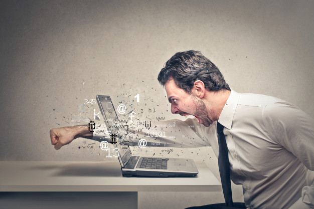Angry-businessman-crushing-his-laptop