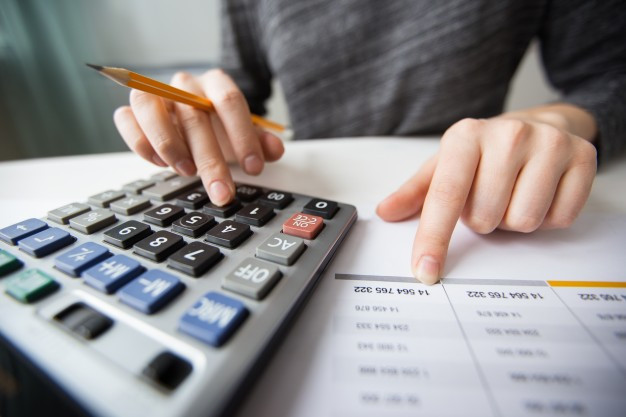 accountant hands counting on calculator