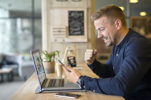 Happy businessman in coffee shop