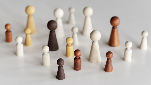 High view diverse wooden characters inclusion concept 